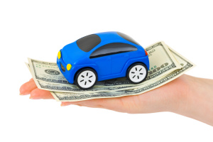 Hand with money and toy car