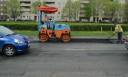 stock-footage-vilnius-lithuania-circa-may-worker-put-hot-asphalt-on-road-street-holes-and-heavy