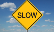 bigstock-Slow-Traffic-Sign-With-Clouds-1373892