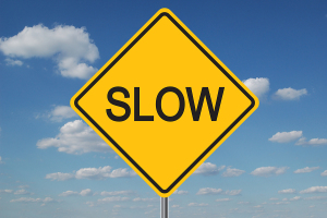 bigstock-Slow-Traffic-Sign-With-Clouds-1373892