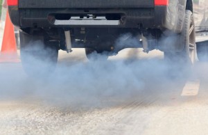 Air pollution from vehicle exhaust pipe on road