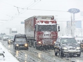 Traffic jam formed at the road caused by heavy snowstorm.