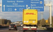 international parcel service DHL truck, drives on german freeway