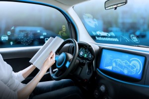 cockpit of autonomous car. a vehicle running self driving mode and a woman driver reading book.