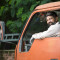 Happy truck driver looking over shoulder